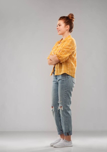 red haired teenage girl in shirt and torn jeans - Photo, image