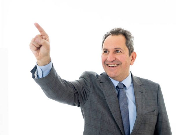 Portrait of a middle aged confident businessman pointing at copy space. Isolated on white. - Φωτογραφία, εικόνα