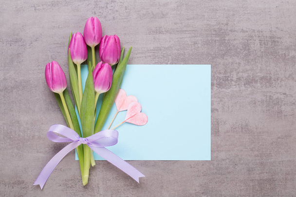 Spring greeting card, pink color tulips on the gray background. - Foto, Imagen
