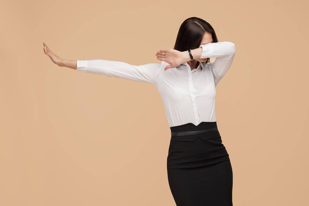 Happy anonymous young modern business woman dance over beige background. Success and winner concept. - Zdjęcie, obraz