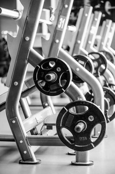 Modern gym interior with bench press equipment in a raw - 写真・画像
