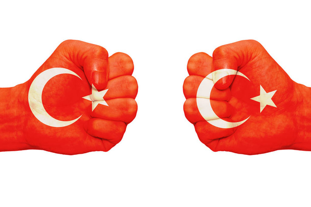 Fists, which bear the image of the flag of Turkey. White background, isolate. - Photo, Image