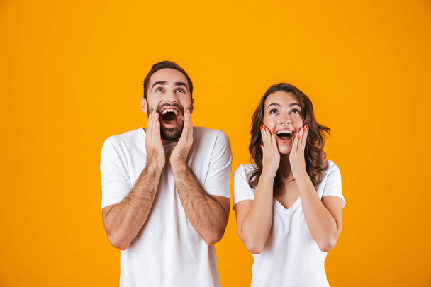 Image of happy people man and woman in basic clothing screaming  - Fotó, kép