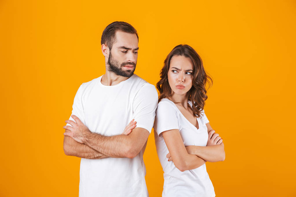 Photo of resented man and woman in quarrel standing back to back - Foto, Imagen