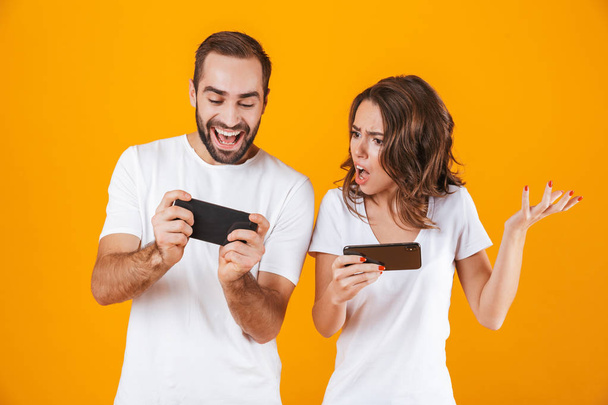 Image of pleased man and woman playing together video games on s - Foto, Bild