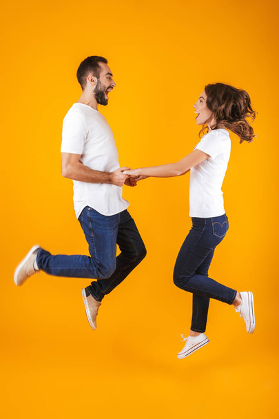 Full length photo of happy couple laughing and holding hands, is - Fotó, kép