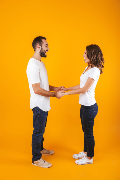 Full length photo of beautiful couple laughing and holding hands - Photo, image