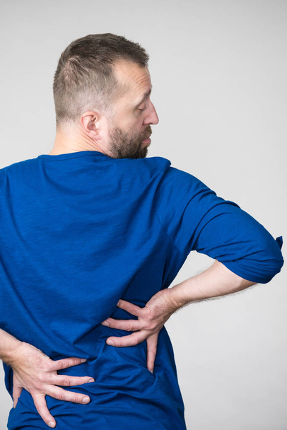 Man having back loins pain ache - Foto, afbeelding