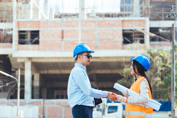 Male engineer meeting woman architect at construction site - Photo, image