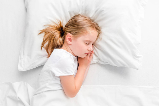 little girl sleeping in white bed - Fotografie, Obrázek