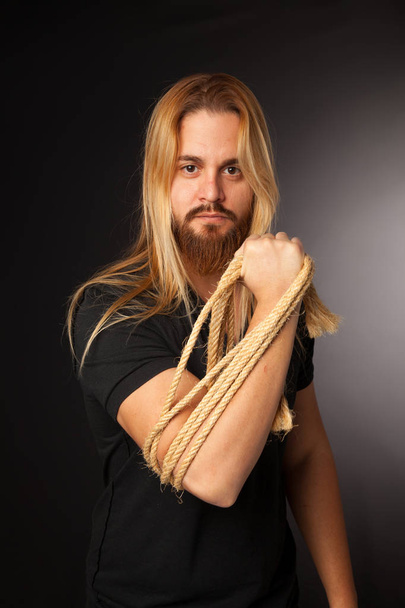 young boy with long hair and beard with rope on his arm - Fotografie, Obrázek