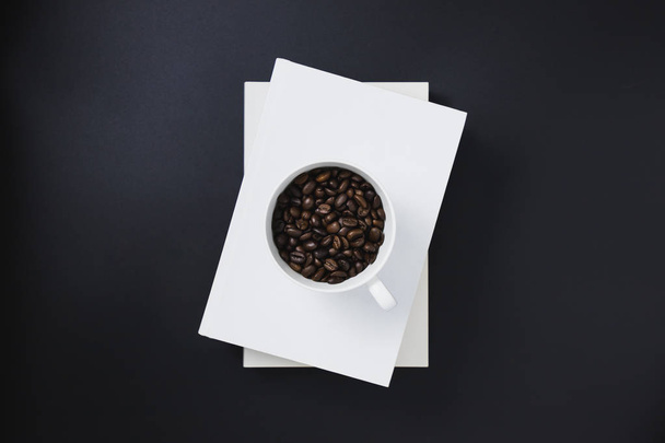 Black coffee in a white coffee mug placed on white books - Photo, Image