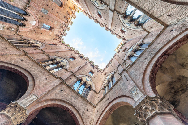 Ancient medieval buildings of Tuscany, upward view from the grou - 写真・画像