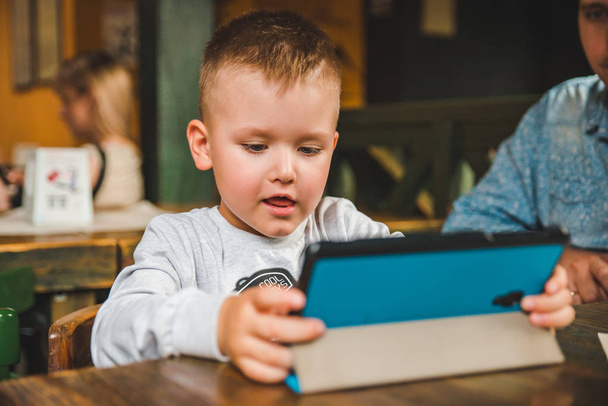 Tablet ile oturan küçük çocuk - Fotoğraf, Görsel