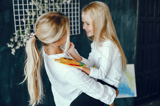 Beautiful mom and daughter are drawing - Zdjęcie, obraz