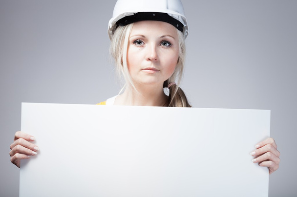 Young builder woman construction worker, empty banner - Photo, Image