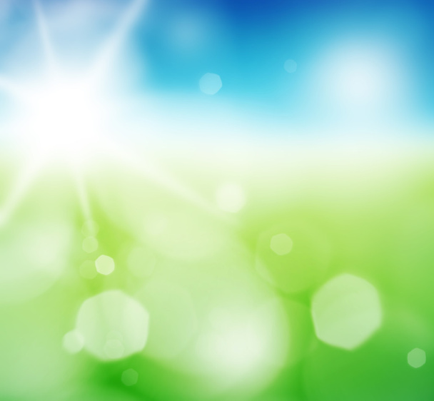 Blurry green field and blue sky with summer sun burst. - Photo, Image