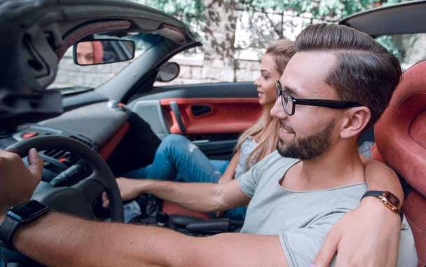 Happy couple inside convertible car in day trip - Photo, Image