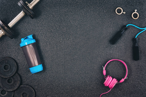 Fitness or bodybuilding background. Dumbbells on gym floor, top view - Фото, зображення