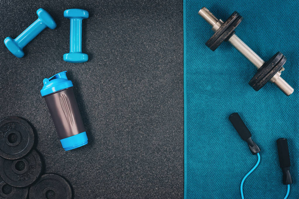 Fitness or bodybuilding background. Dumbbells on gym floor, top view - Foto, Imagen