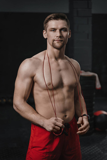 Vertical shot portrait of young handsome shirtless athlete at th - Photo, Image