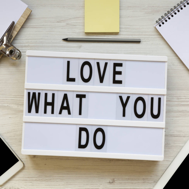 'Love what you do' words on lightbox, tablet, smartphone, notepa - Zdjęcie, obraz