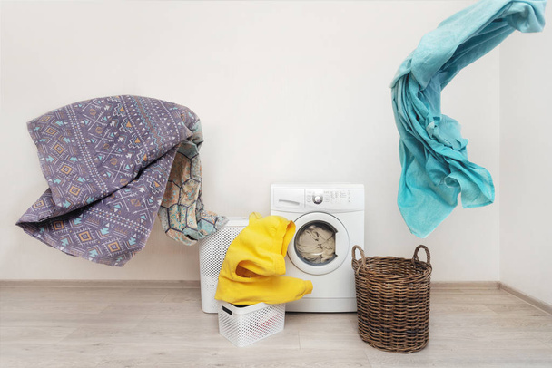 Laundry room interior with washing machine near wall - Фото, зображення