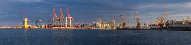 Loading grain to the ship in the port. Panoramic view of the ship, cranes, and other infrastructures of the port. - Photo, Image