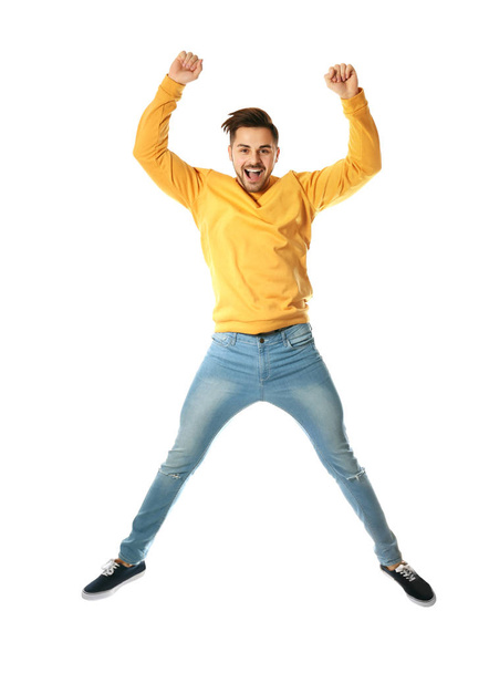 Full length portrait of happy handsome man jumping on white background - Valokuva, kuva