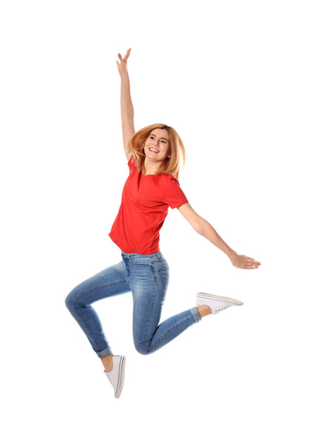 Full length portrait of happy beautiful woman jumping on white background - Фото, зображення