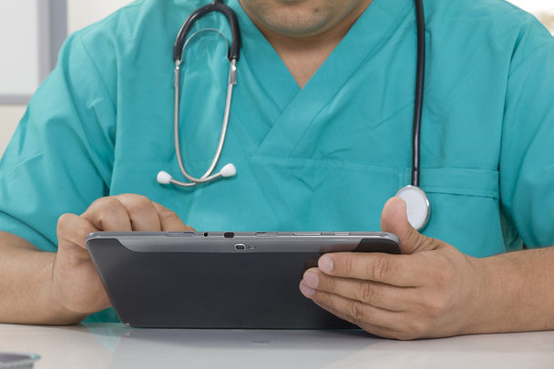 Doctor working on a digital tablet - Photo, image