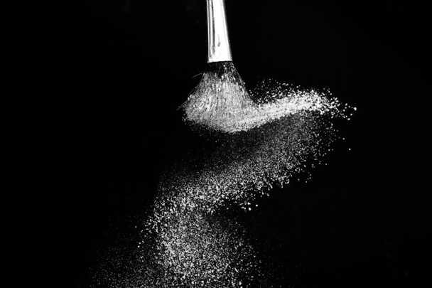 Cosmetic brush with white cosmetic powder spreading - Φωτογραφία, εικόνα