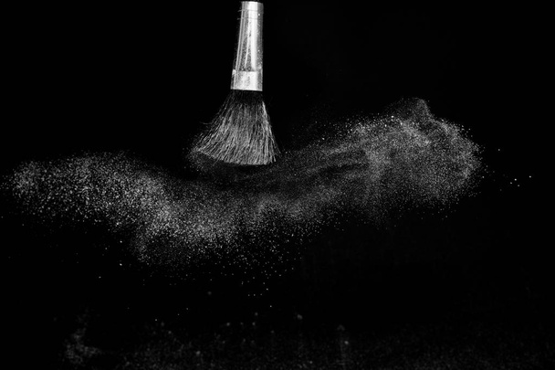 Cosmetic brush with white cosmetic powder spreading - Photo, Image