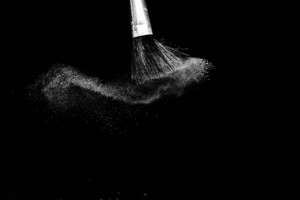 Cosmetic brush with white cosmetic powder spreading - Photo, Image