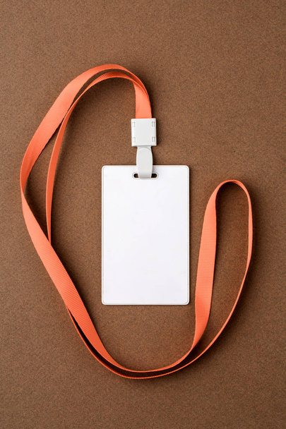 Empty security tag on brown background. Place for text, layout. - Photo, Image