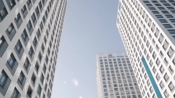 Angle view of white skyscrapers against blue sky. Frame. Fantastic below view - Footage, Video