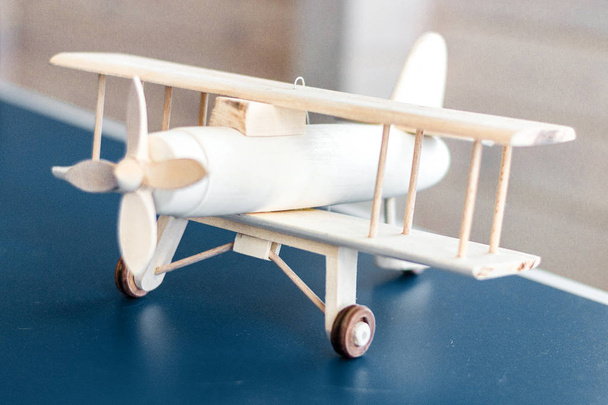 Vintage wooden airplane model. Retro style. Game model. Focus airplane. - Fotografie, Obrázek