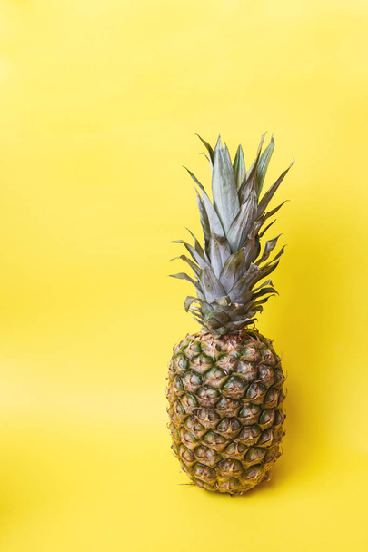 Ripe pineapple on a yellow toned background - Fotoğraf, Görsel