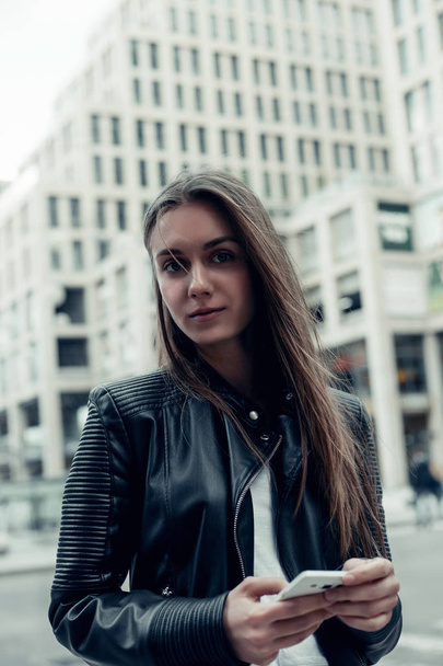  Pretty young woman with long hair in leather jacket  - Foto, immagini