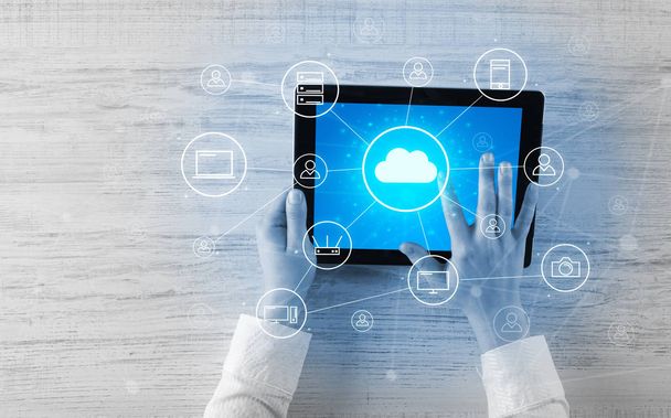 Hand using tablet with centralized cloud computing system concept - Photo, image