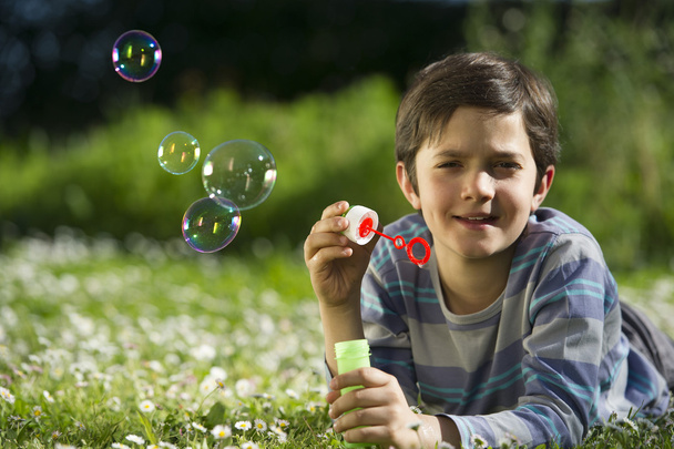 Child playing and blow soap bubbles - Фото, зображення