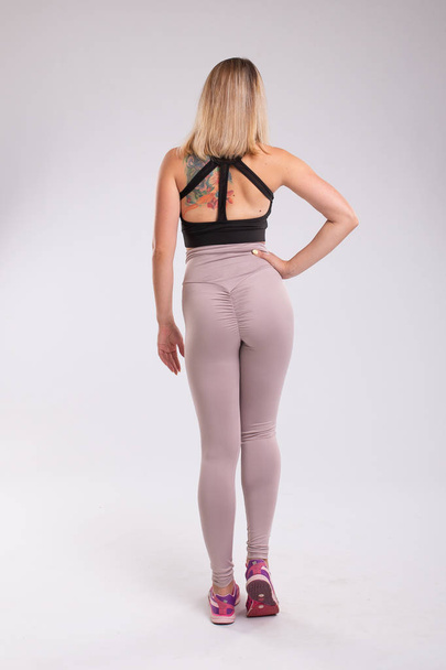 Back view of sporty woman. Rear view of sitting sportive woman w - Photo, Image