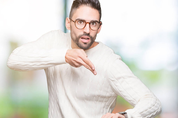 Young handsome man wearing glasses over isolated background In hurry pointing to watch time, impatience, upset and angry for deadline delay - Photo, Image