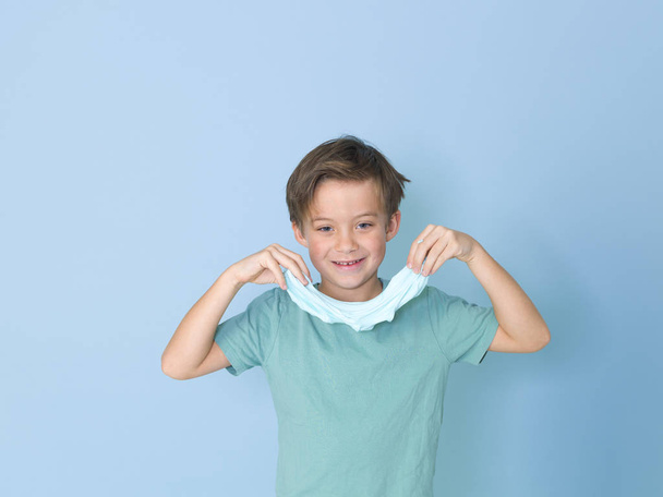 little boy plays having fun while playing with with homemade slime in front of blue background  - Foto, Imagem