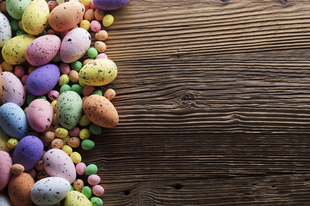 Easter background. Easter eggs. Rustic wooden table. Top view. - Photo, Image