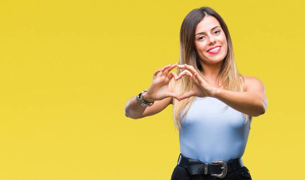 Young beautiful elegant business woman over isolated background smiling in love showing heart symbol and shape with hands. Romantic concept. - Foto, imagen