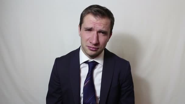 Young handsome businessman sighing and shaking his head in frustration. - Imágenes, Vídeo