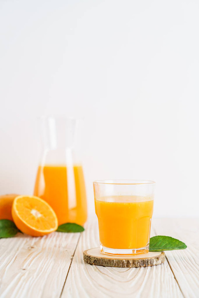 Fresh orange juice on wood background - Photo, image
