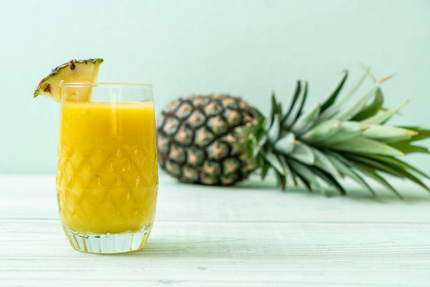 fresh pineapple smoothie glass on wood table - Fotoğraf, Görsel