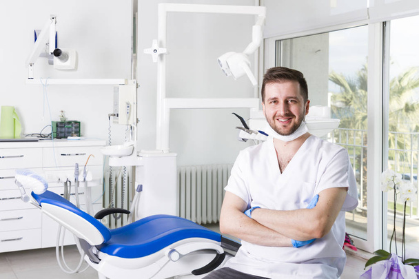 Junger Zahnarzt in Uniform in Zahnklinik - Foto, Bild